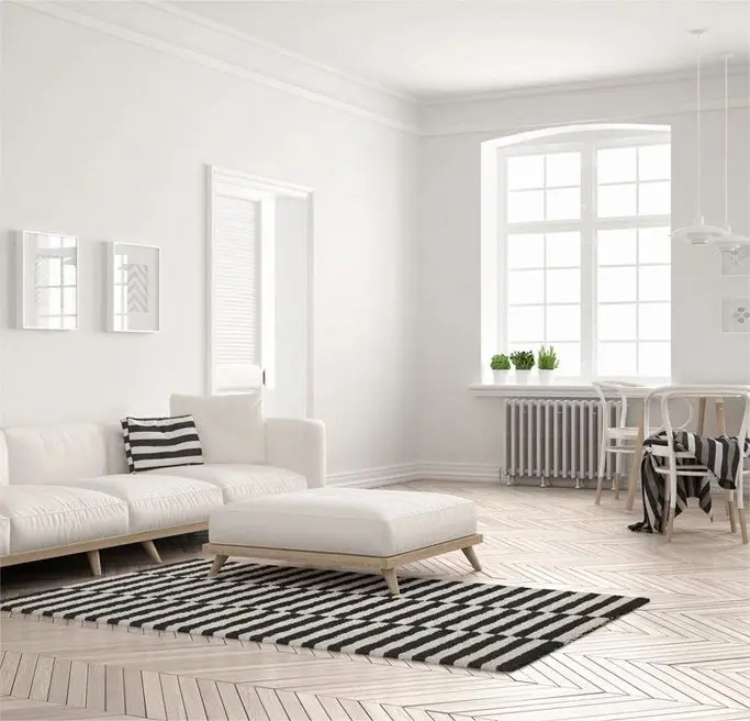 A white living room with a couch and a table.