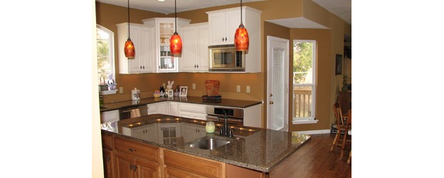 A kitchen with a granite island.